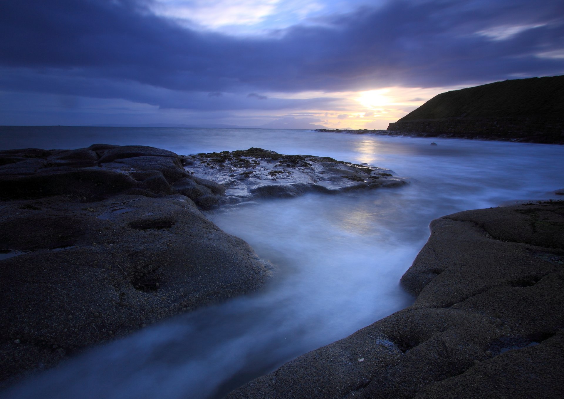 tarde mar océano costa piedras montaña lejos sol puesta de sol cielo nubes azul