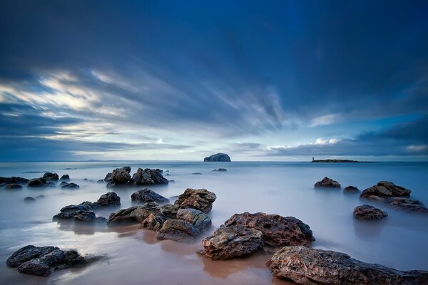 The sky is the color of the sea over the beach stones