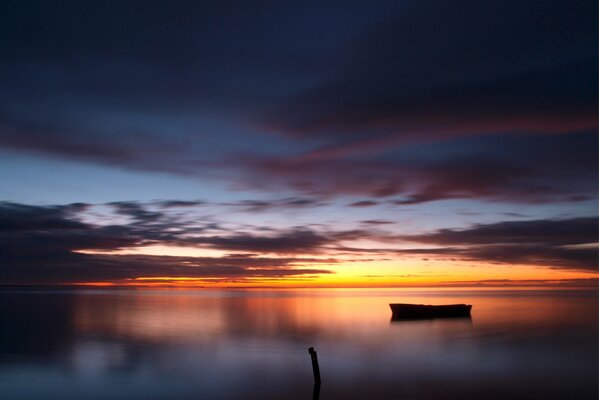 Boat on the lake in the evening sunset