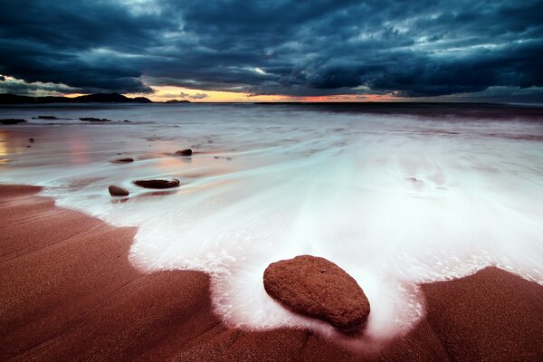 Sea foam of the sea at sunset