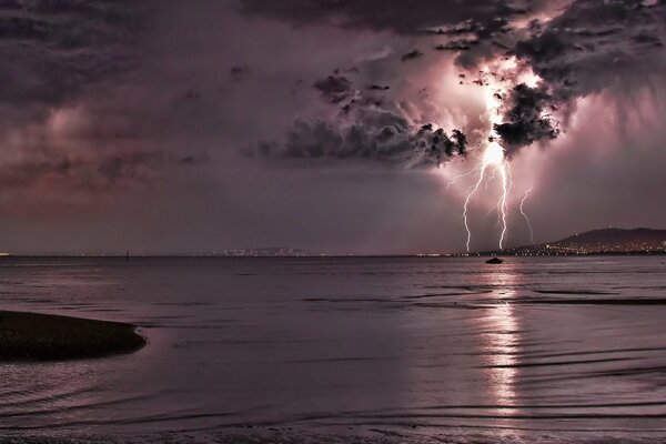 Night sea view with lightning in the sky