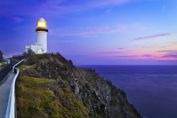 Evening sunset with a view of the lighthouse and the blue sea