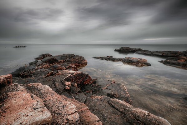 The sea, the rocks, the gray sky-how beautiful