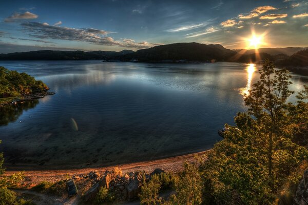 Atmospheric evening photo of a pond in the rays of sunset