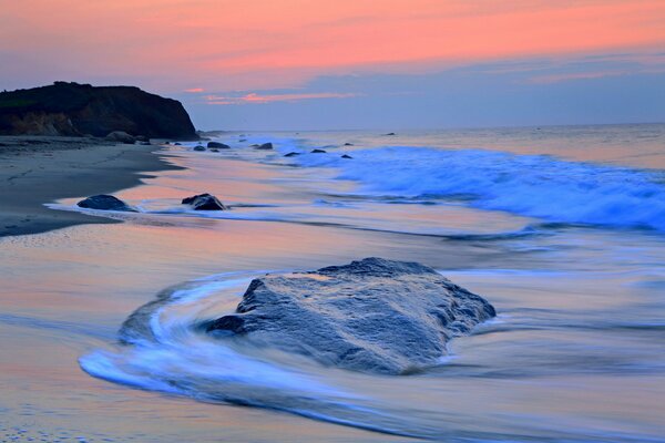 Sea waves on the evening beach