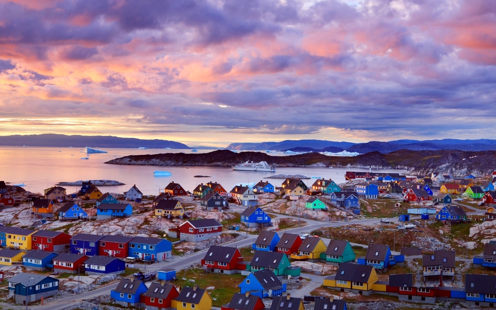 groenlandia costa témpanos de hielo ferry casas multicolor montañas nubes puesta de sol rosa