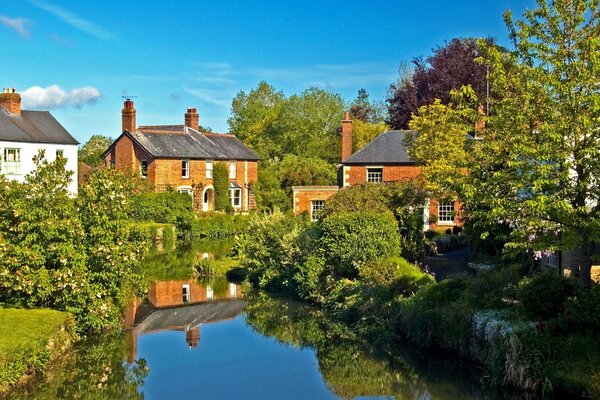 Cute houses of England surrounded by green trees