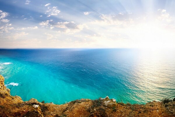 Seascape with rocks and sun