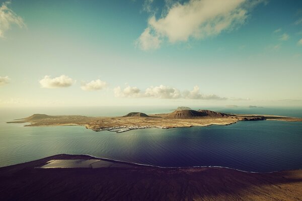 Grey island among the green waters