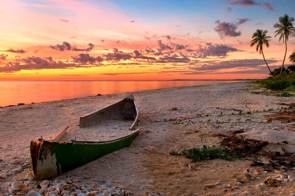 Sandy beach by the sea with a boat