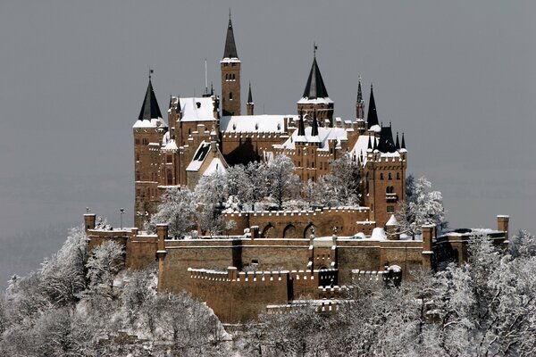 German castle on a mountain in the snow