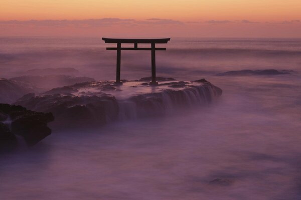 The Japanese gate. Rocks in the fog by the sea