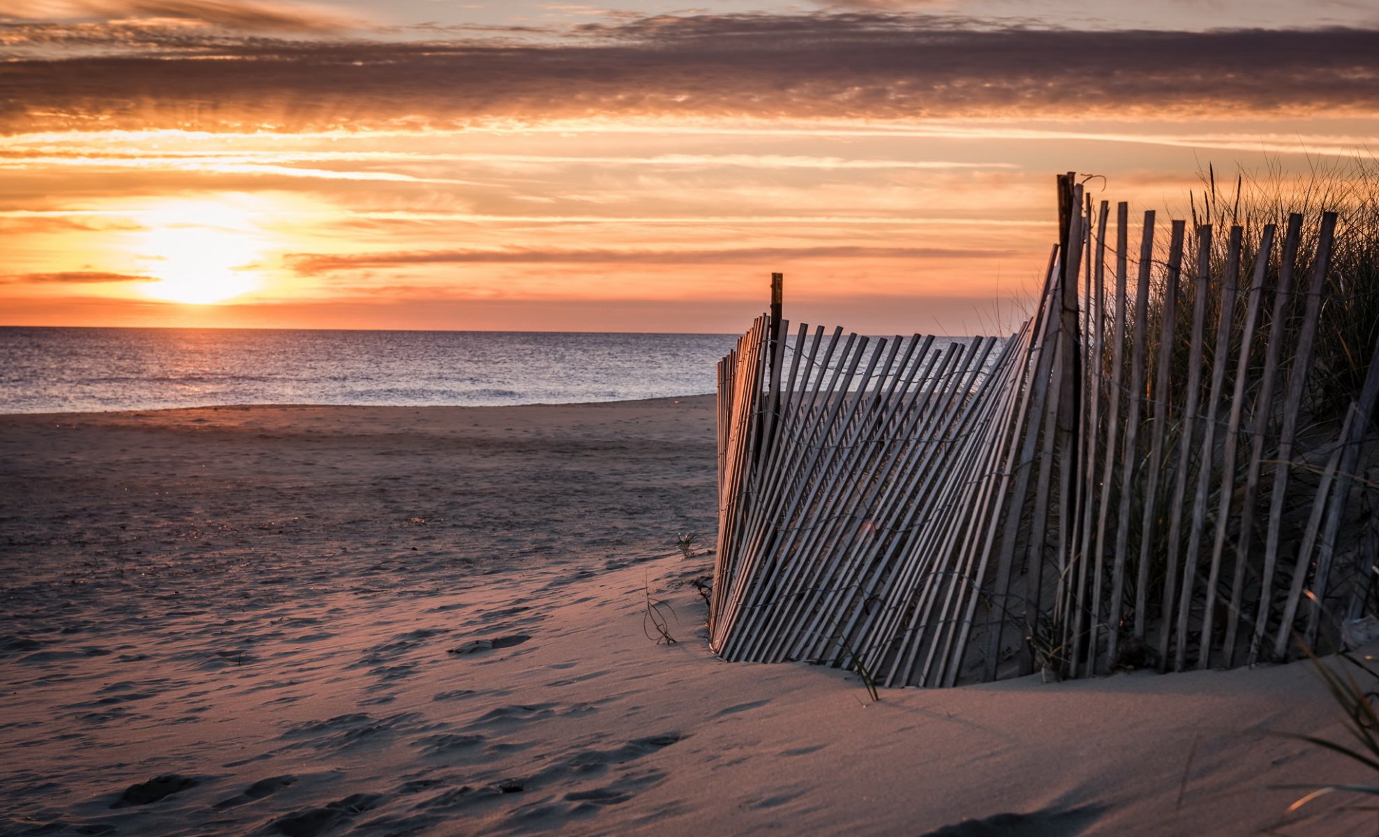 unset sea fence beach landscape