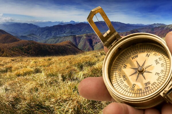 Compass on the background of a mountain landscape