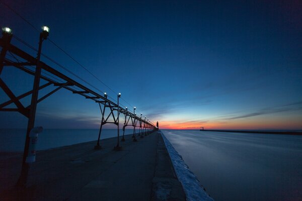 A bridge with fanaries on the background of sunset