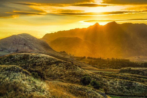 Yellow sky over picturesque mountains