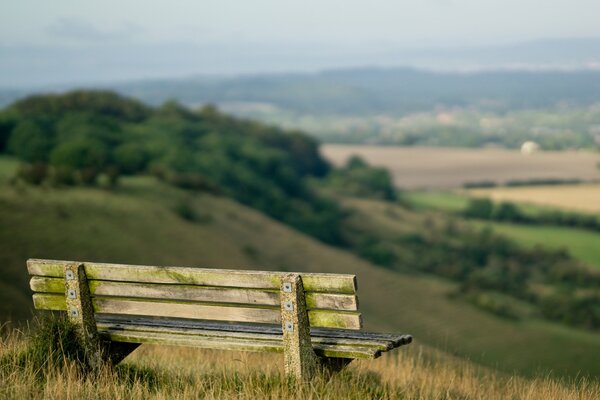 Landscape with wooden bench and sky