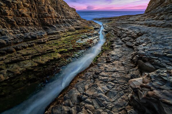 Water flows through a crack in the rock