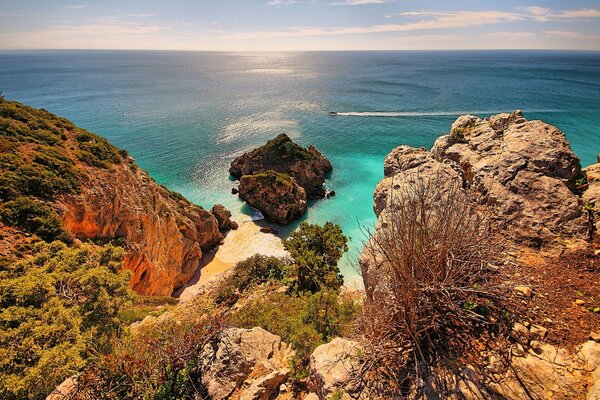 The boat floats on turquoise water