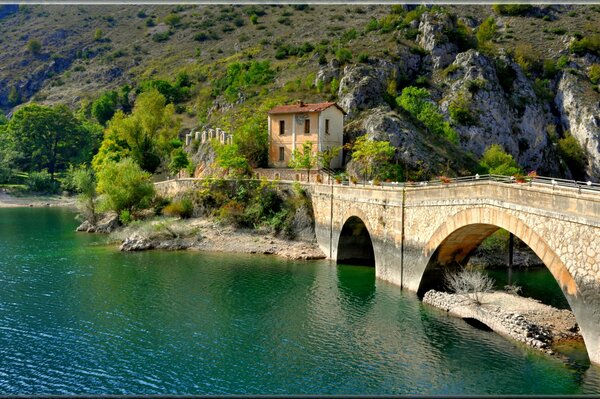 A house by the water. Lake and mountains