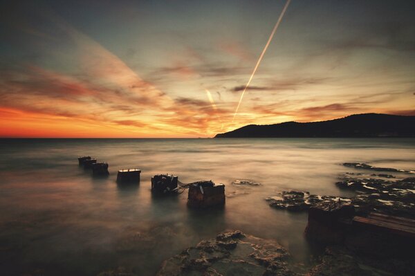 The rocky coast of Ibiza in the rays of the setting sun