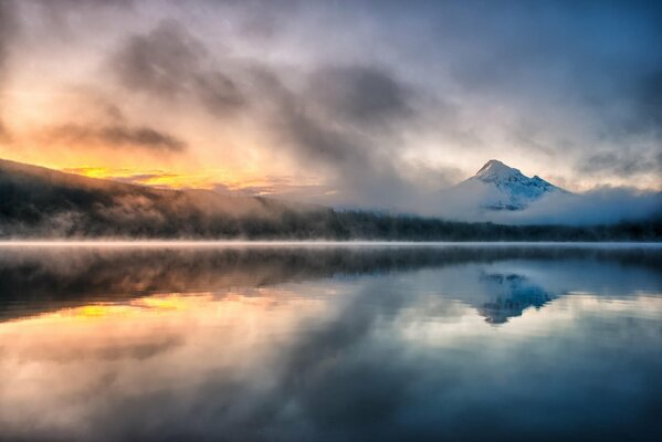 Morning foggy lake on the background of mountains