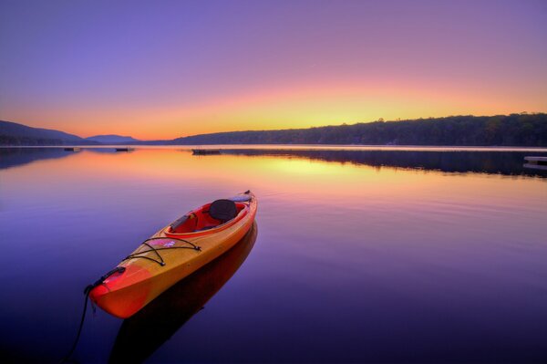 Kayak at dawn on a Calm river