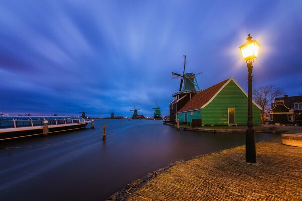 Night lamp lighting and a green house by the river