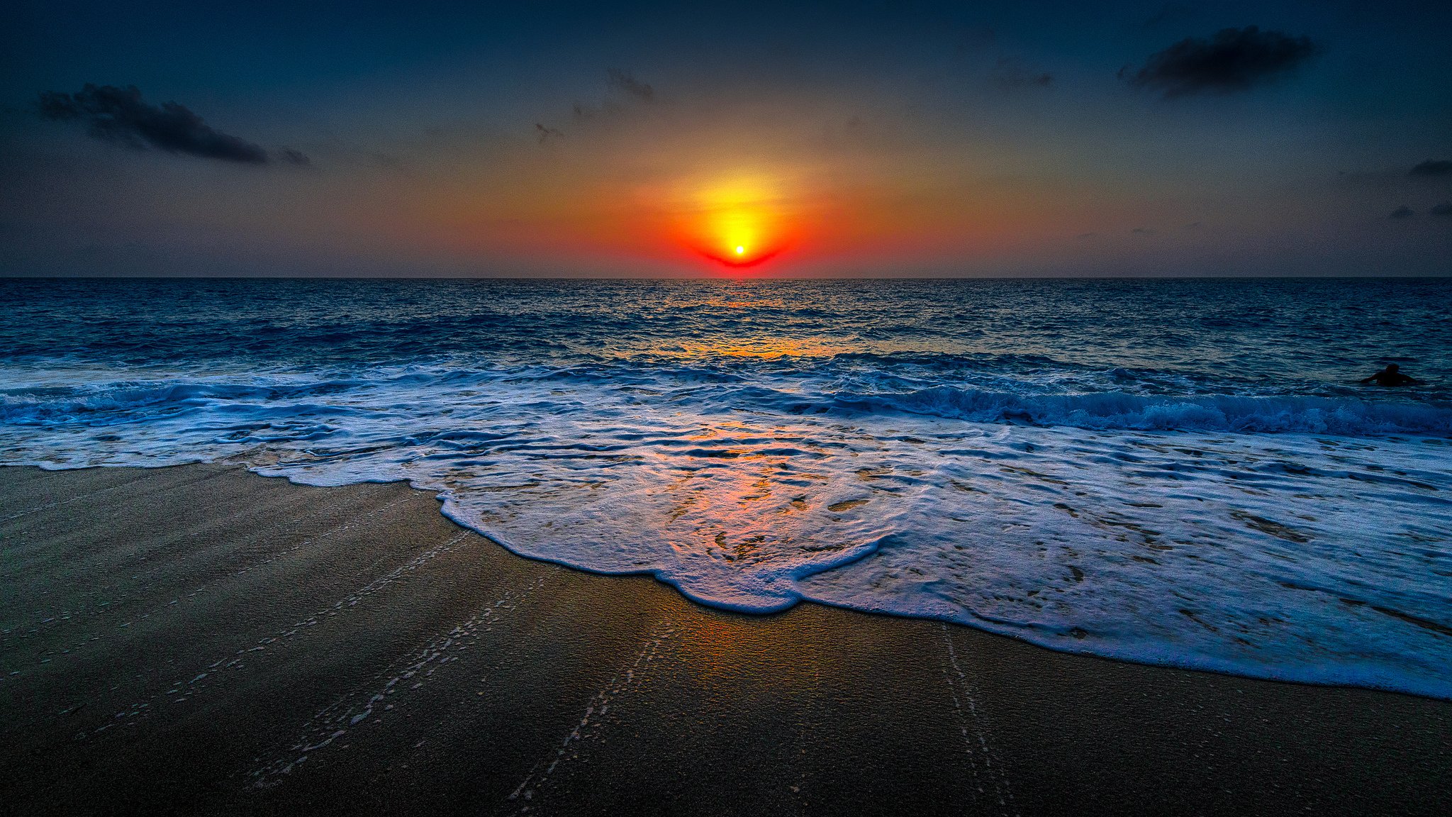 ocean water sand beach sky clouds horizon sunset sun