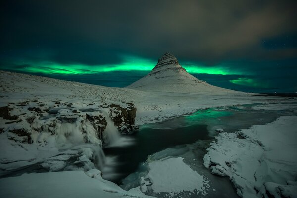 Aurora boreale in Islanda vicino a un vulcano