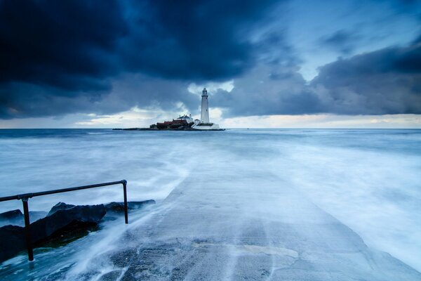 Lighthouse in the distance of a frozen lake