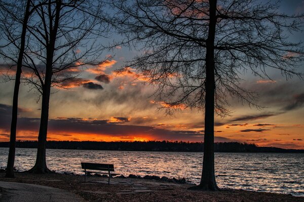 Landscape bench on the background of sunset