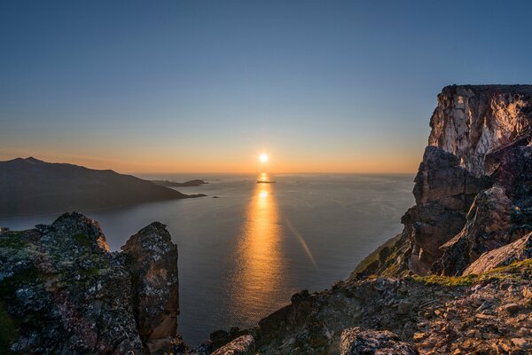 Sunset on the background of mountains and the sea