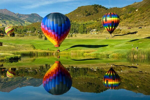 Flying balloons over a lake in the mountains