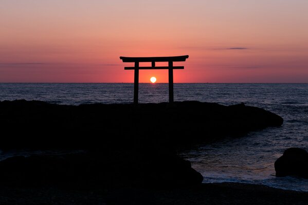 Japanese torii on the ocean sunset