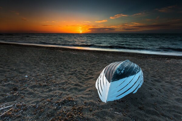 Seascape with a boat at sunset