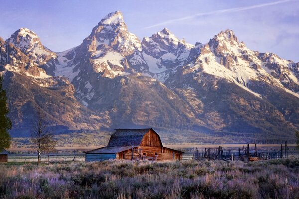 A house on the background of snow-capped mountains