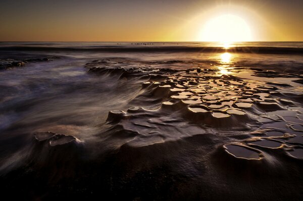 The stunning beach reflects the sunset