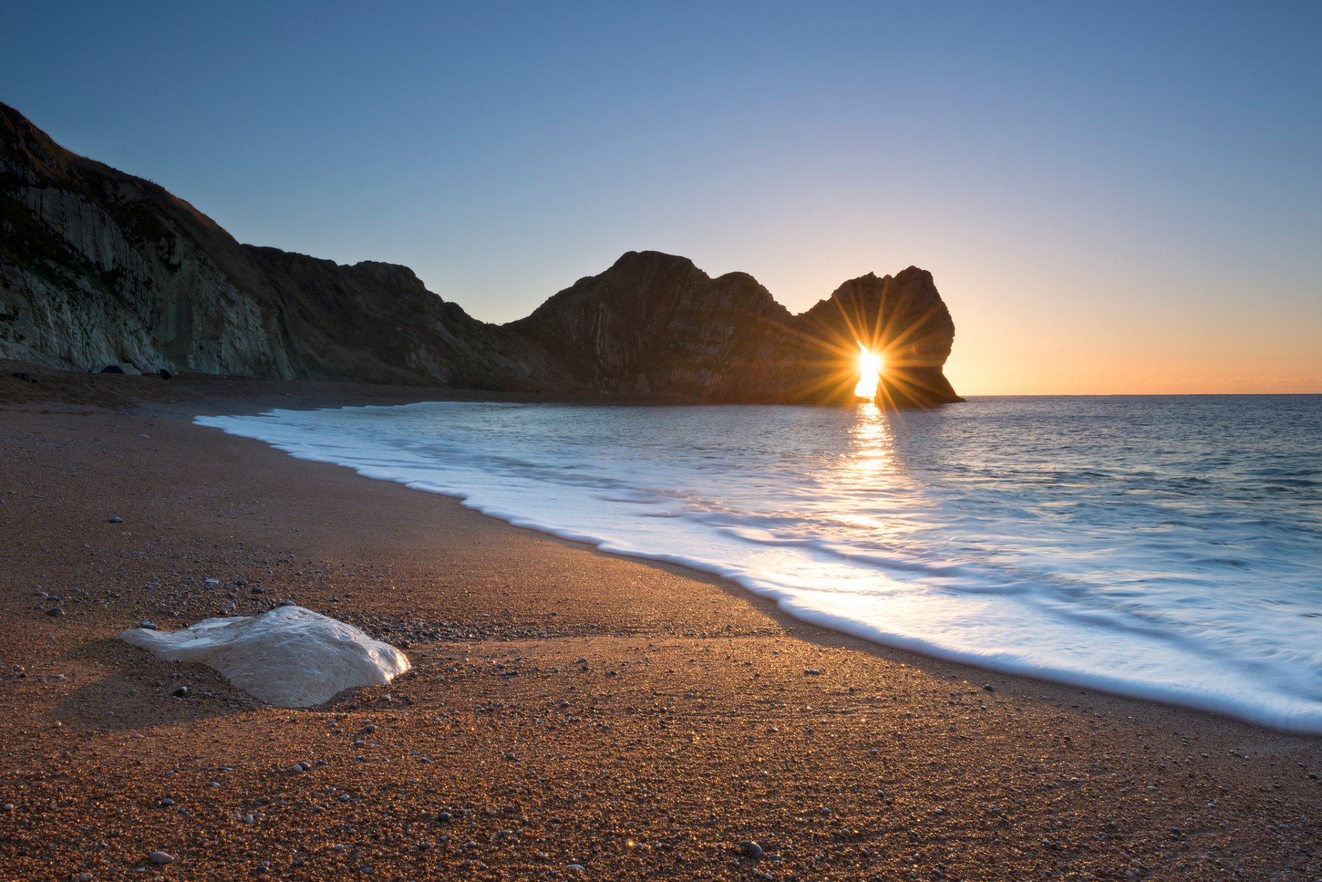 england jurassic coast rocky gate durdle door beach morning light sun rays winter december