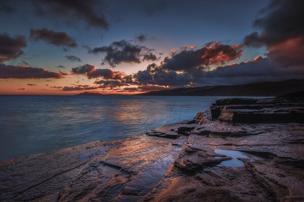 The seashore and clouds in the light of the passing day