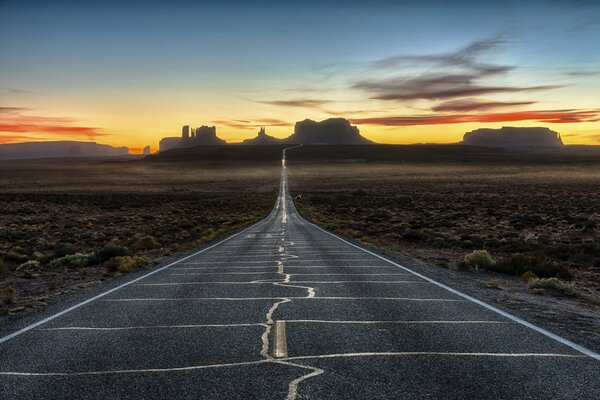 A smooth road with a landscape on the mountains