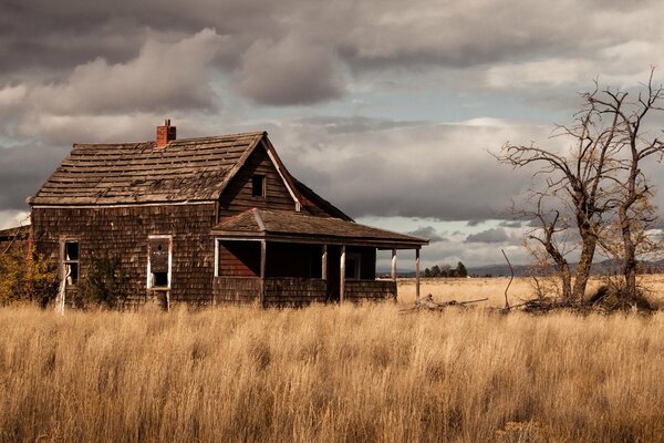 A field with an old house