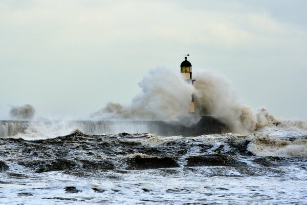 Storm in the sea near the lighthouse