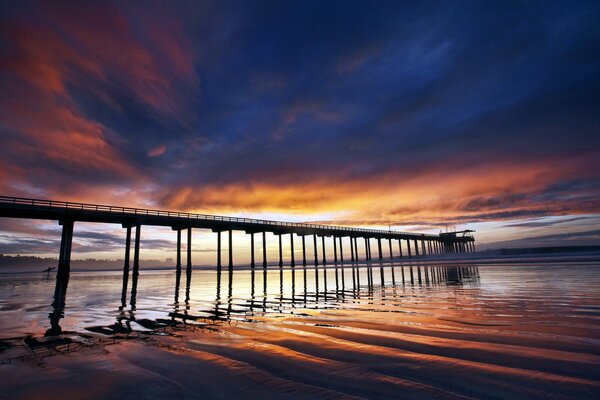 Bellissimo tramonto sullo sfondo del ponte sul mare