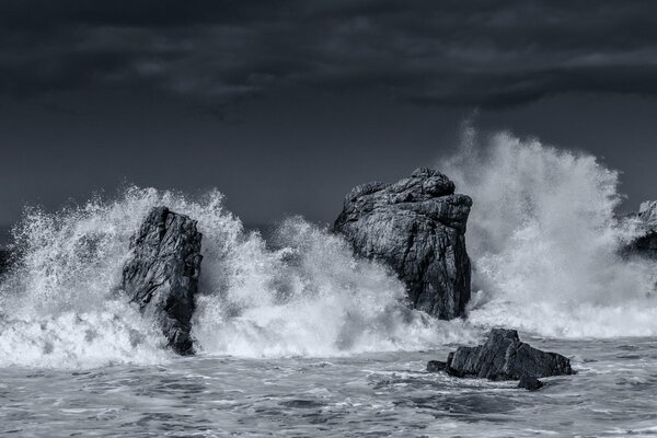 An ocean storm. Waves crashing against rocks