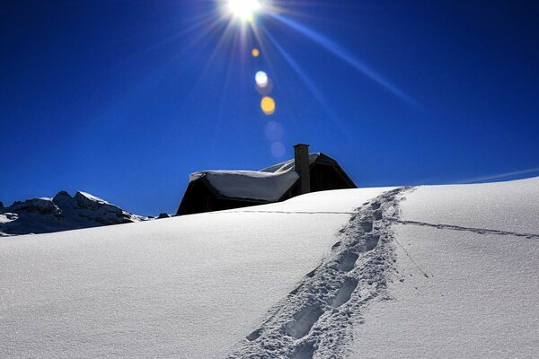 Footprints in the snow against the blue winter sky