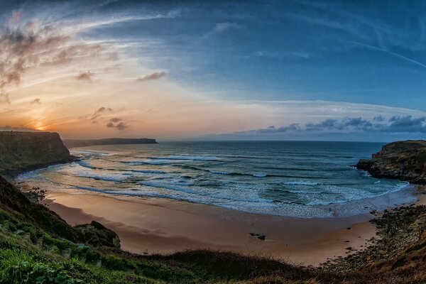 The sun illuminates the beach by the sea