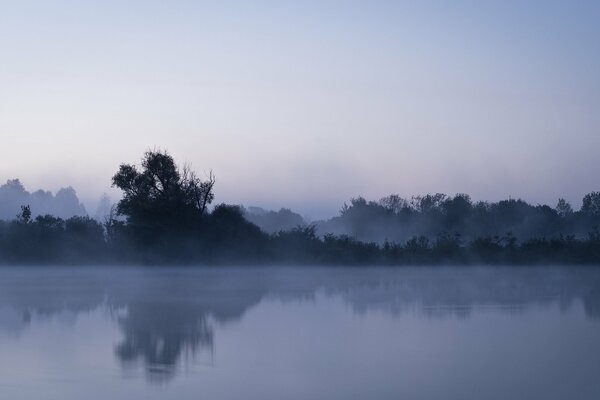 Gray fog over the river at night