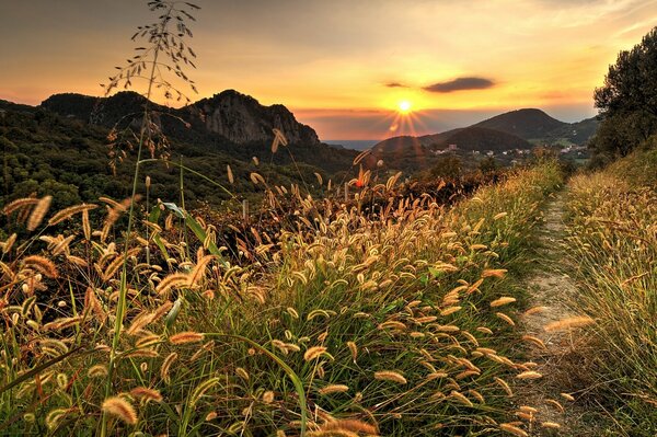 The road leading to a beautiful sunset in the mountains