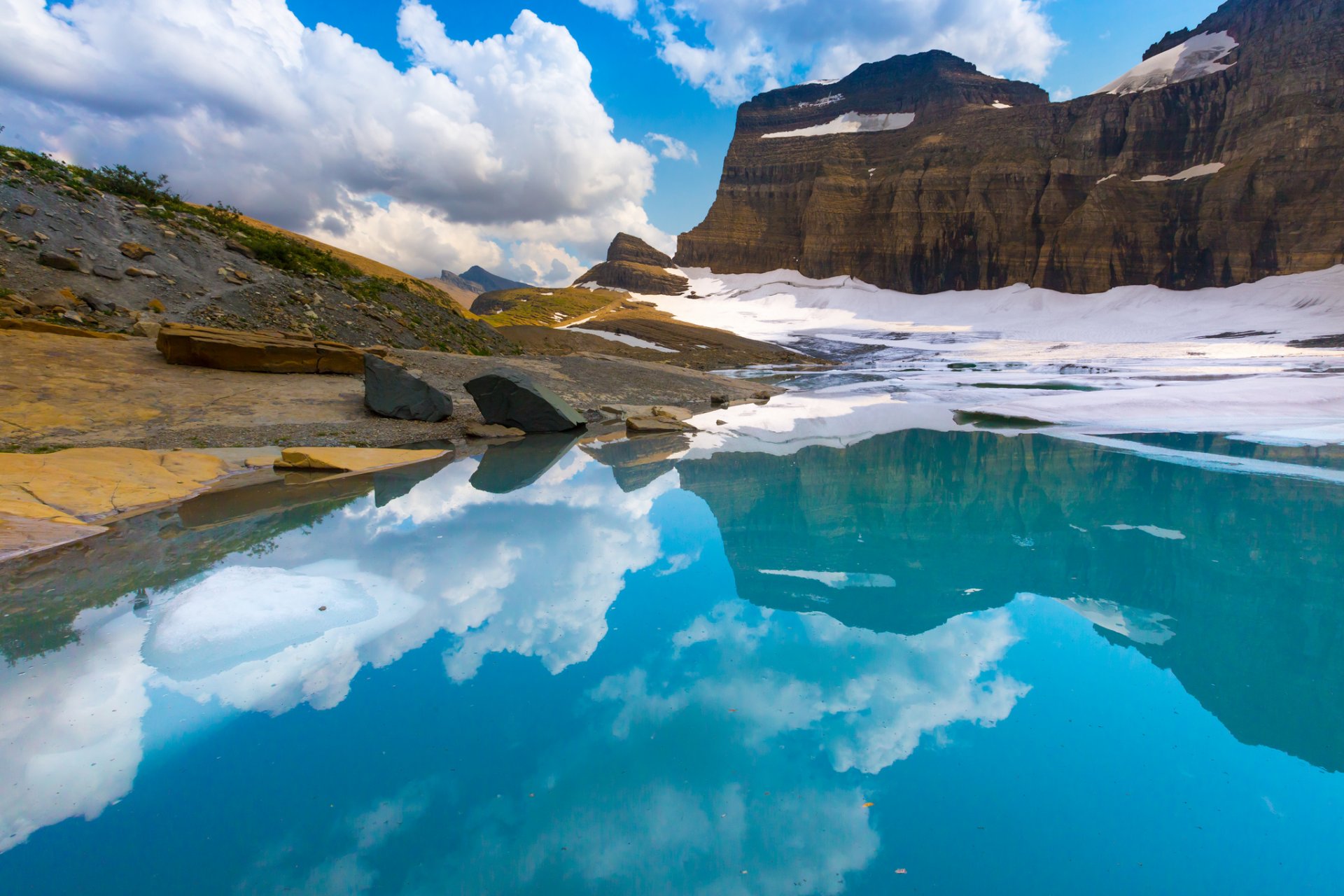 rock lake snow sky clouds reflection